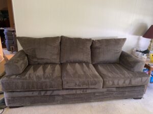 Freshly cleaned sofa with restored fabric, looking bright and refreshed after a professional upholstery cleaning.