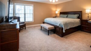 Clean beige carpet in a cozy bedroom after professional carpet cleaning service by Rent A Vet Carpet Cleaning in St. Charles, MO, showing fresh and spotless carpets