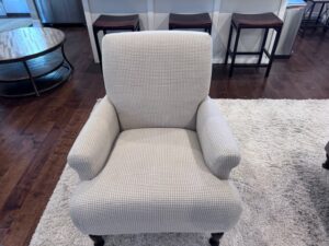 Freshly cleaned wingback chair with vibrant, spotless upholstery in a cozy, well-lit room, highlighting its polished and renewed appearance.